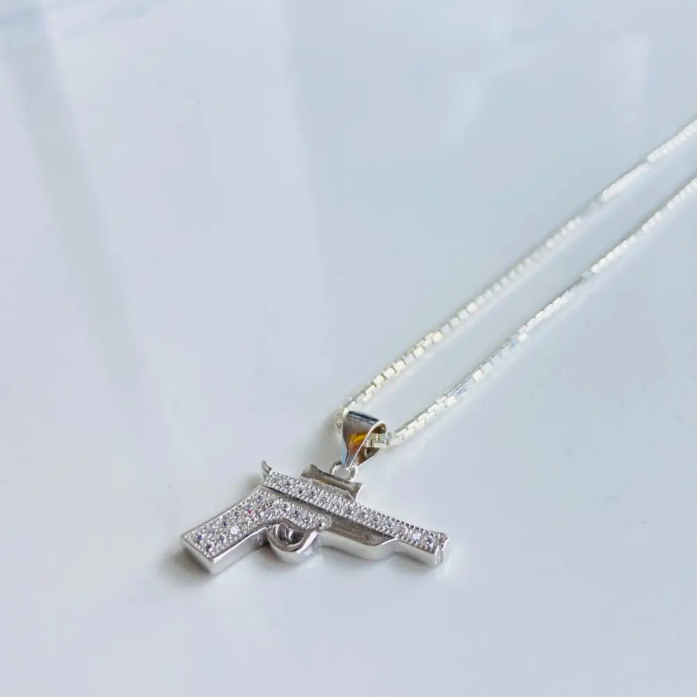 Silver pistol pendant necklace with cubic zirconia in white gold silver finish
