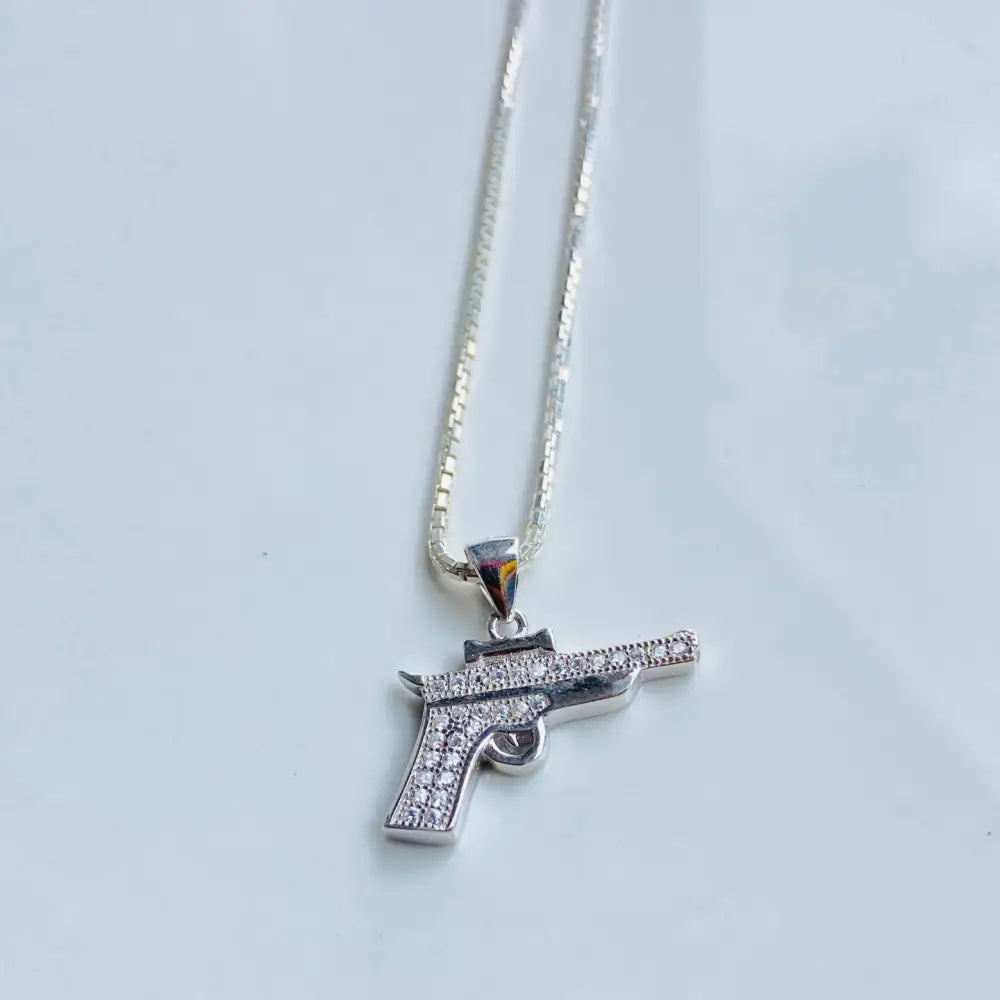 Silver pistol pendant necklace with cubic zirconia in white gold silver finish