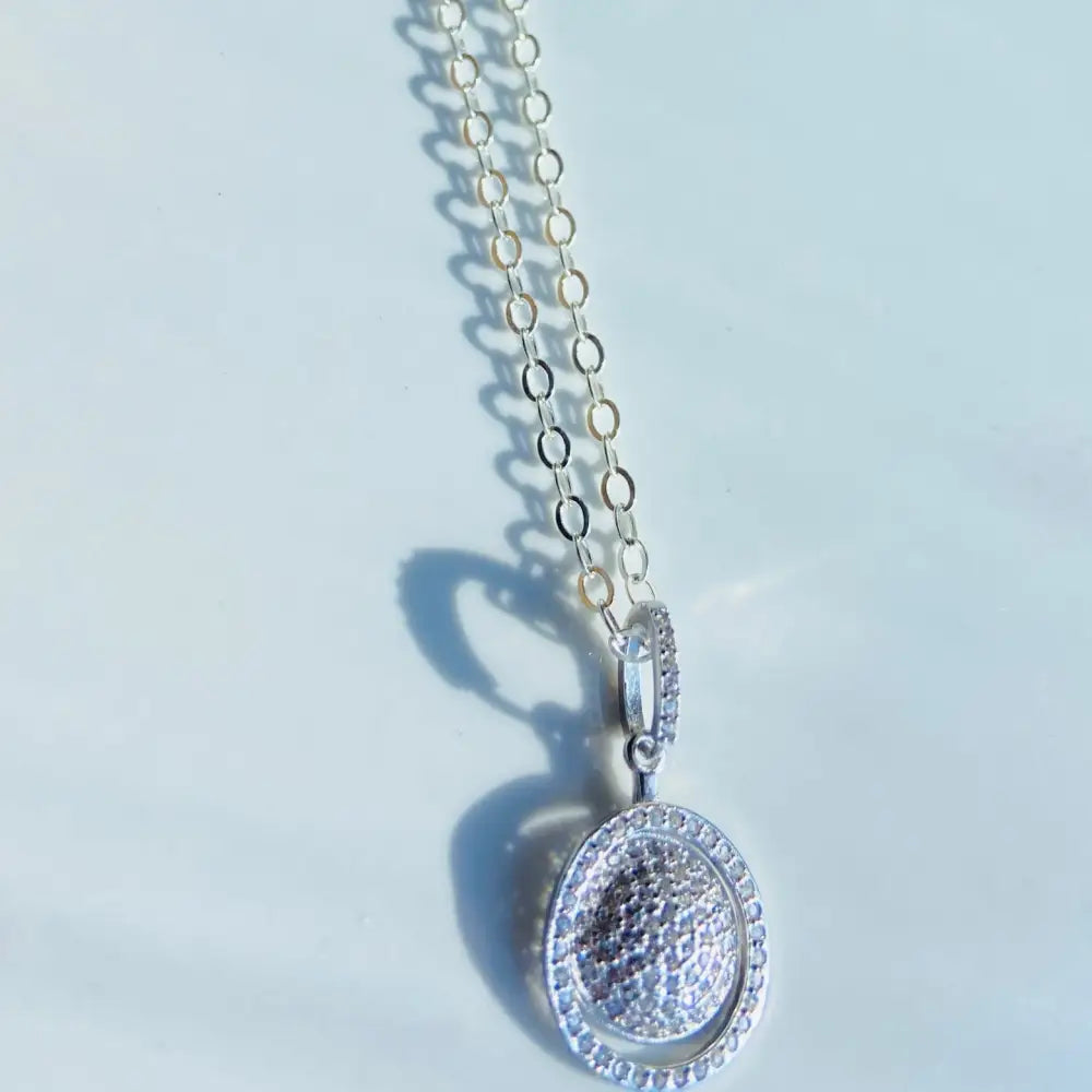 Silver chain necklace with a pavé-set diamond sphere ring pendant in white gold silver. Jewellery silver jewellery Deep Shine Jewellers