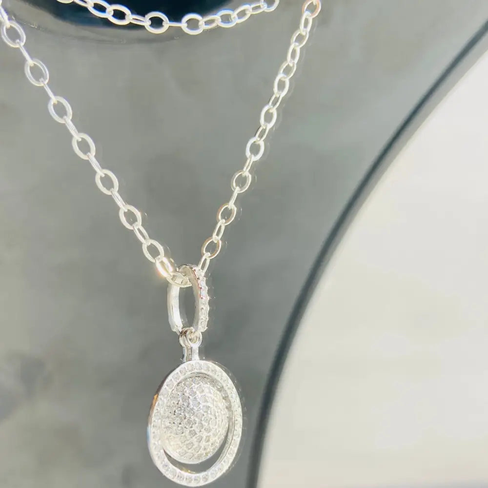 Silver chain necklace with a sparkling rotating oval pendant in white gold silver finish. Jewellery silver jewellery Deep Shine Jewellers