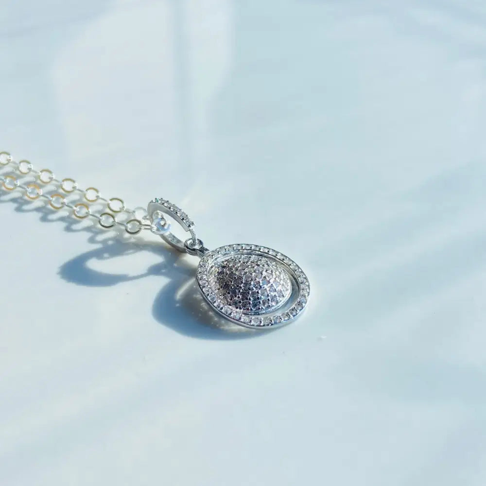 Silver pendant with pave-set dome-shaped center and oval halo, part of a white gold silver sphere ring necklace. Jewellery silver jewellery Deep Shine Jewellers