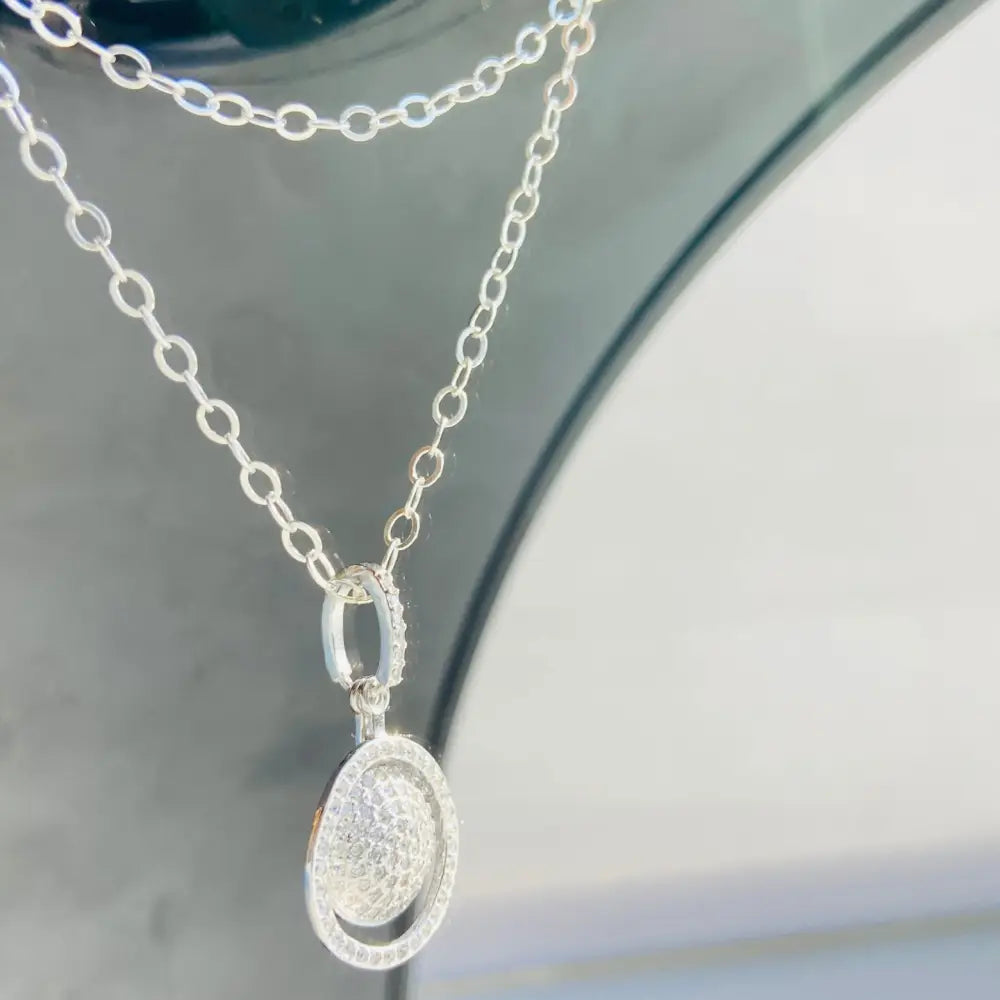 Sparkling silver chain necklace with white gold silver oval pendant and sphere ring design. Jewellery silver jewellery Deep Shine Jewellers