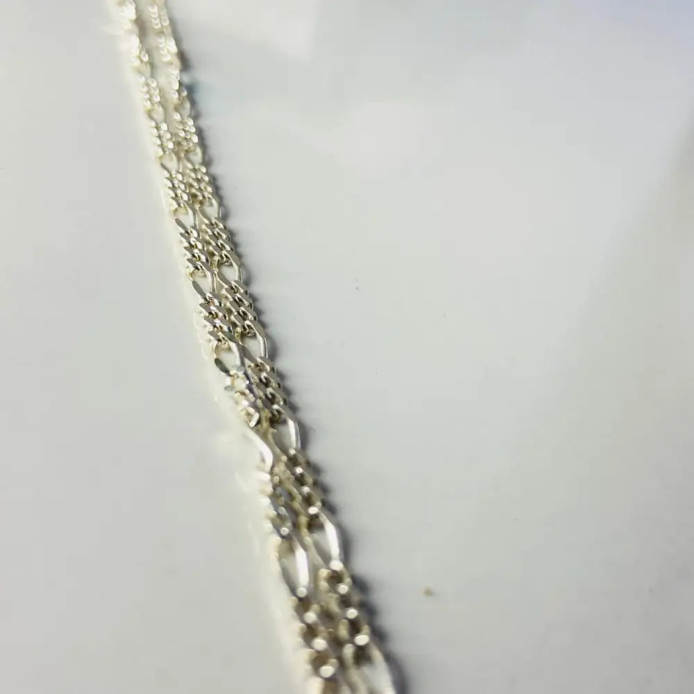 Three strands of silver Figaro chain necklace with white gold accents in elegant design. jewellery silver jewellery. Deep Shine Jewellers