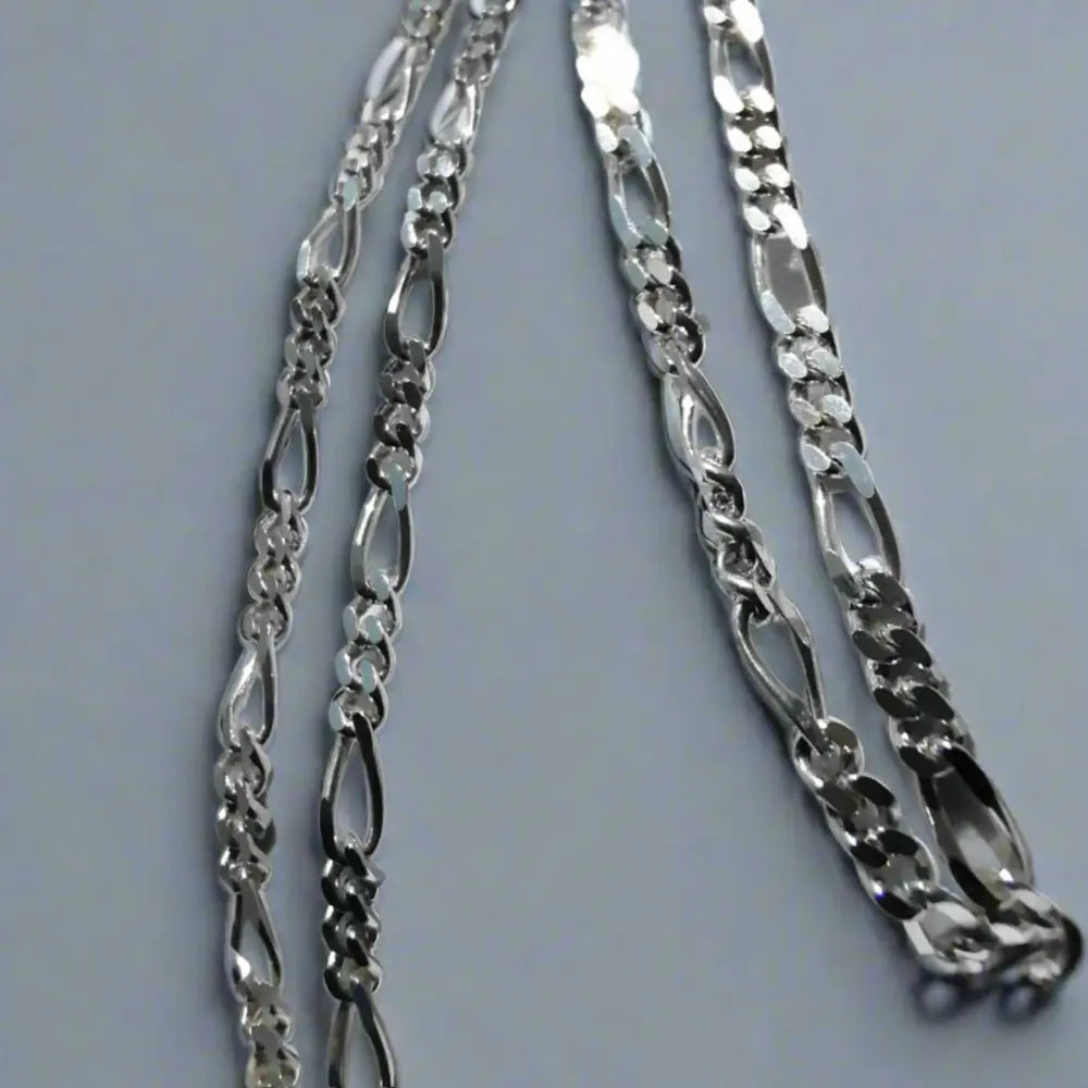 Four silver-colored Figaro chain necklaces featuring sparkling white gold silver accents. jewellery silver jewellery
