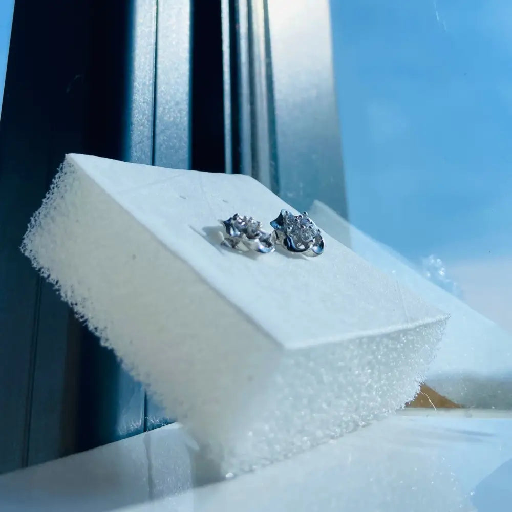 White gold silver ice pave flower stud earrings with intricate textured designs