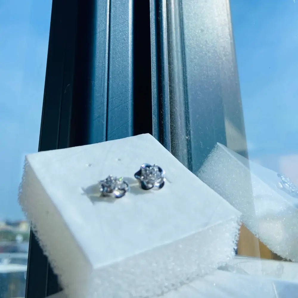 White gold silver ice pave flower stud earrings with diamond accents