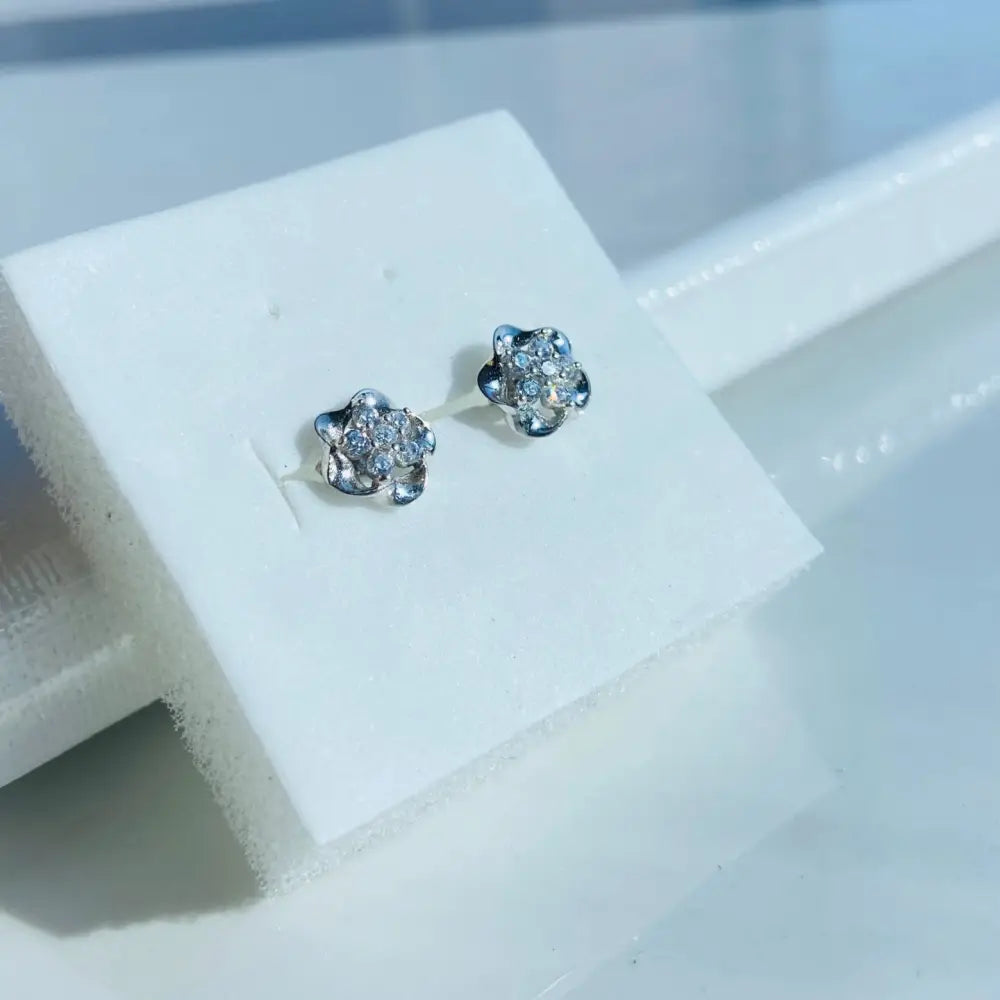 White gold silver ice pave flower stud earrings with diamond accents