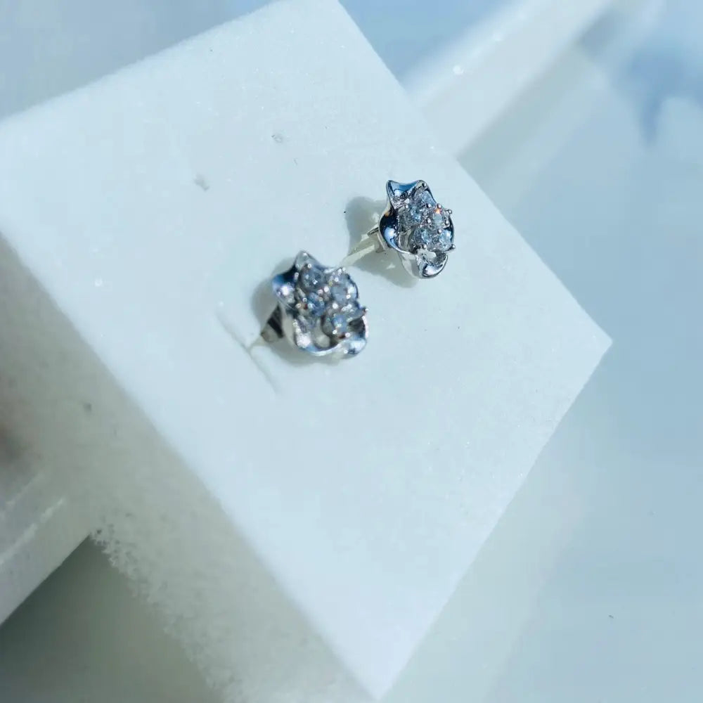 White gold silver ice pave flower stud earrings with sparkling gemstone cluster