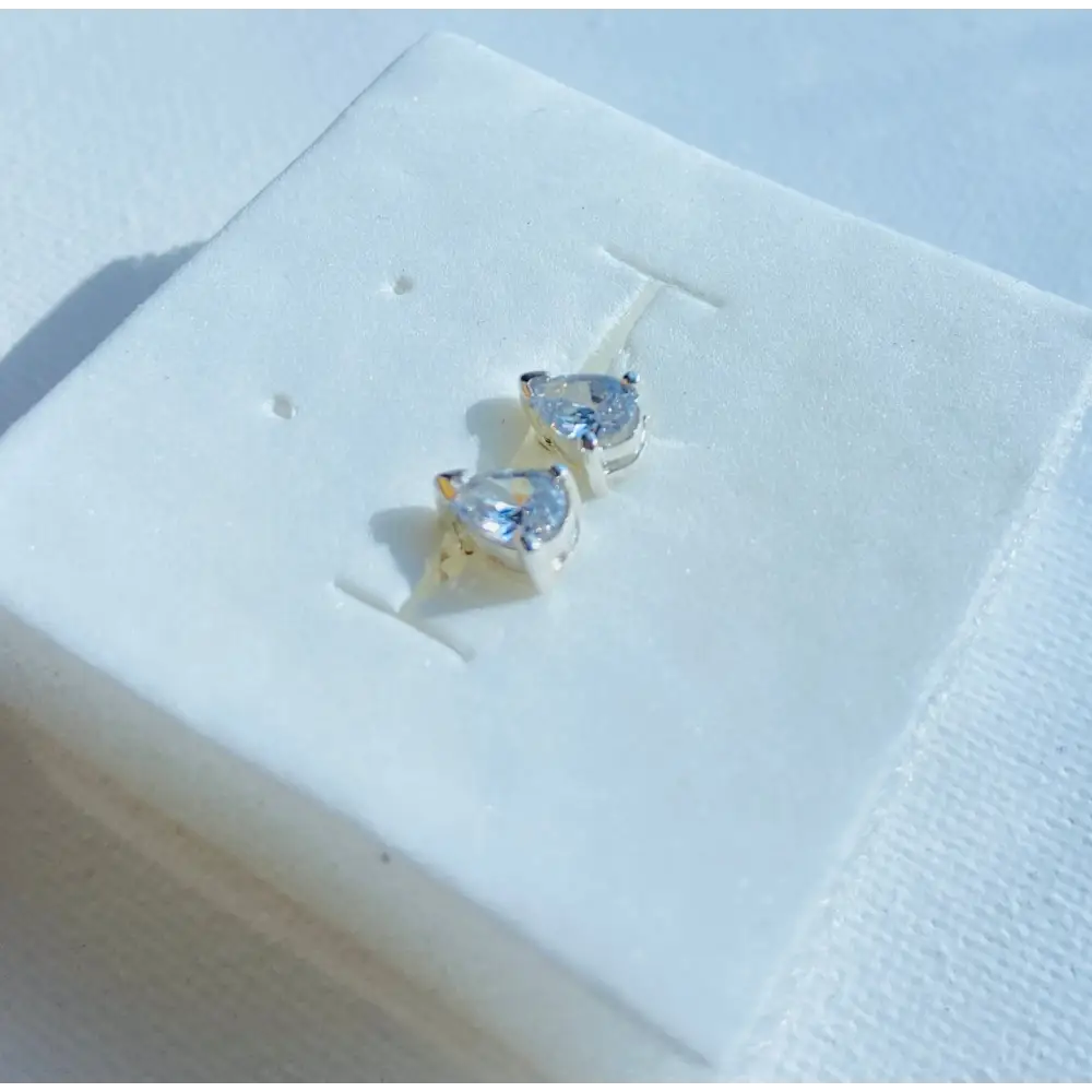 White gold silver set Pear Earrings featuring heart-shaped solitaire studs with radiant shine