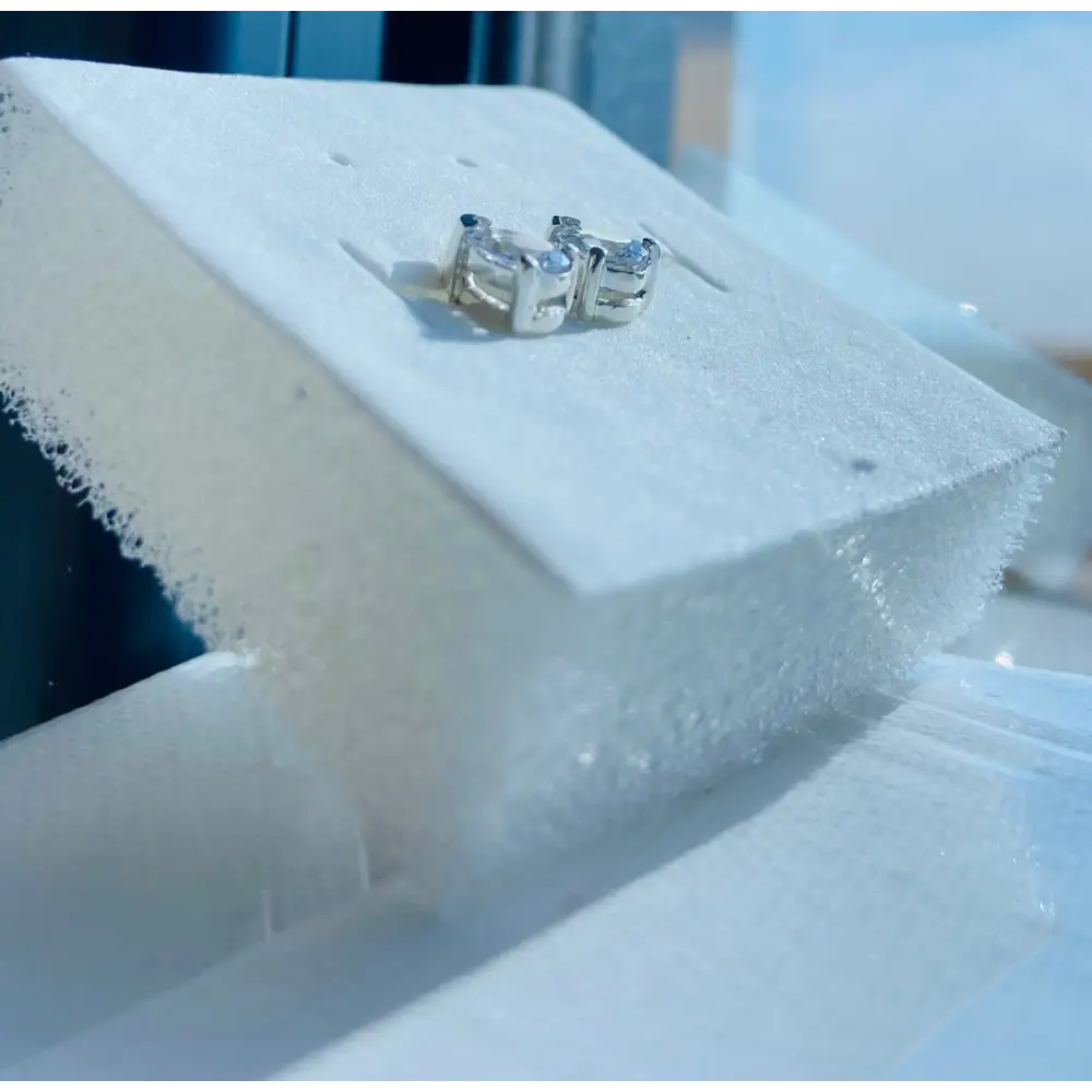 White gold silver pair of stud earrings with clear faceted stones for elegant jewelry