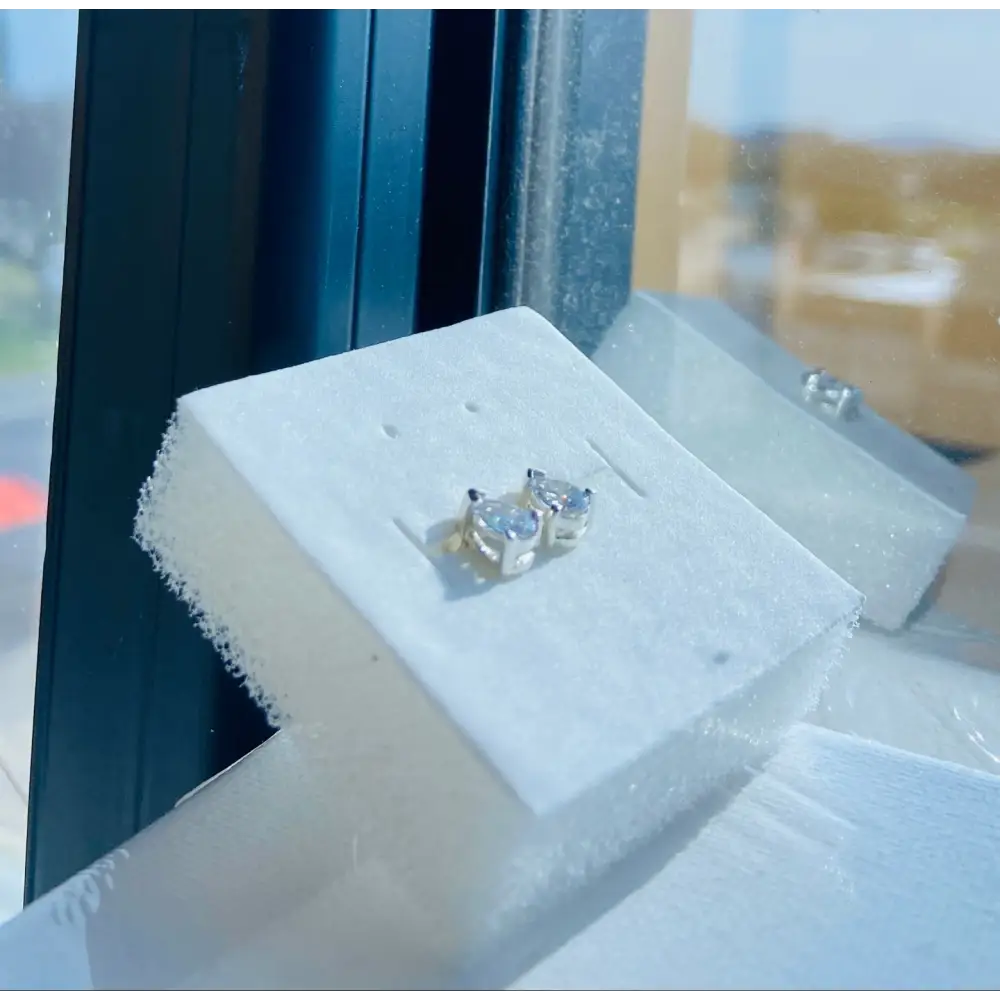 White gold silver set pear-shaped gemstone stud earrings with radiant shine