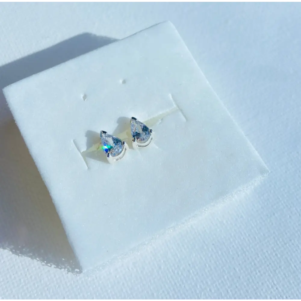 White gold silver set pear-shaped gemstone stud earrings with radiant shine